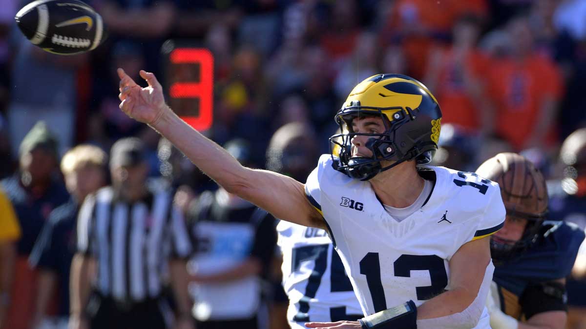 Michigan Wolverines quarterback Jack Tuttle (13) passes the ball against the Illinois Fighting Illini during the first half at Memorial Stadium.