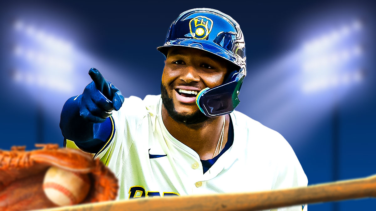 Jackson Chourio smiles in Brewers gear with baseball bat