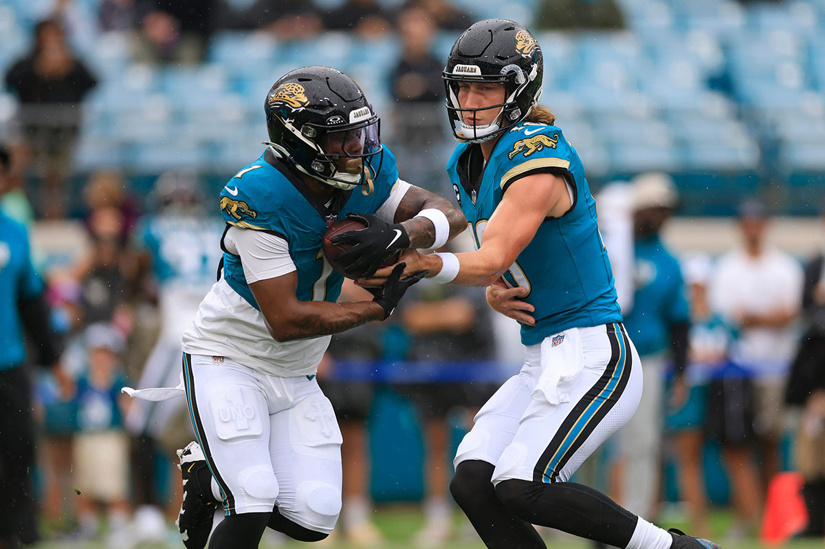 Jaguars quarterback Trevor Lawrence (16) hands off to running back Travis Etienne Jr. (1) before an NFL football matchup Sunday, Oct. 6, 2024 at EverBank Stadium in Jacksonville, Fla.