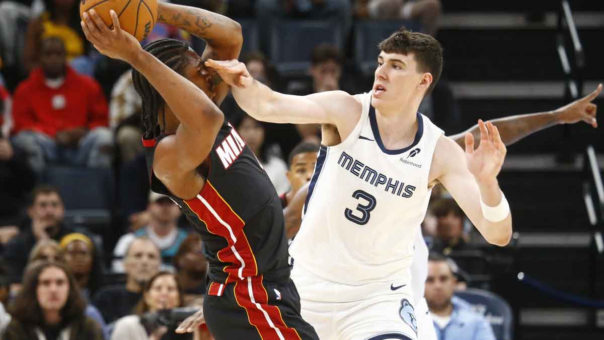 Memphis Grizzlies forward Jake LaRavia (3) defends Miami Heat guard Josh Christopher (8) during the second half at FedExForum.