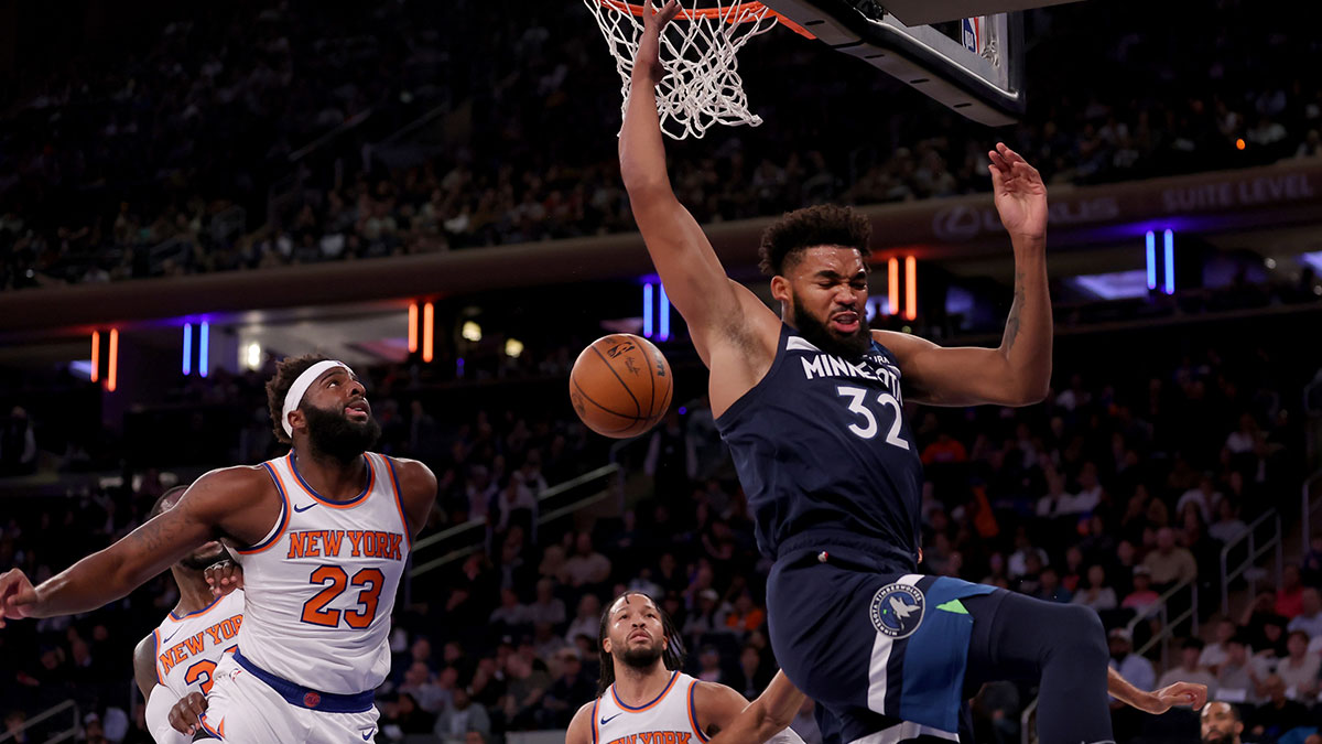 Minnesota Timberwolves center Karl-Anthony Towns (32) reacts after a dunk against New York Knicks center Mitchell Robinson (23) and guard Jalen Brunson (11) during the first quarter at Madison Square Garden