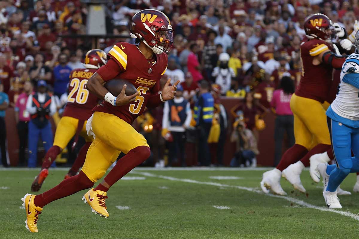  Landover, Maryland, USA; Washington Commanders quarterback Jayden Daniels (5) runs with the ball against the Carolina Panthers during the first quarter at Northwest Stadium.