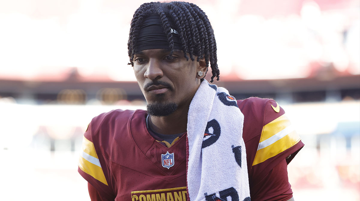 Washington Commanders quarterback Jayden Daniels (5) walks off the field during the first quarter after an injury against the Carolina Panthers at Northwest Stadium.