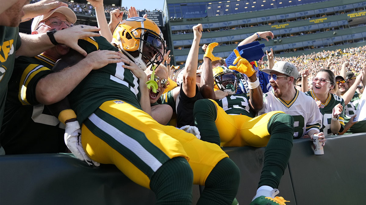 Green Bay Packers wide receiver Dontayvion Wicks (13) and wide receiver Jayden Reed (11) celebrate after scoring a touchdown during the first quarter against the Indianapolis Colts at Lambeau Field.