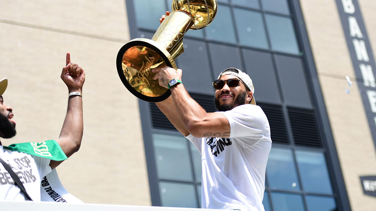 Boston Celtics player Jayson Tatum holds the Larry OíBrien trophy during the Boston Celtics Championship parade.
