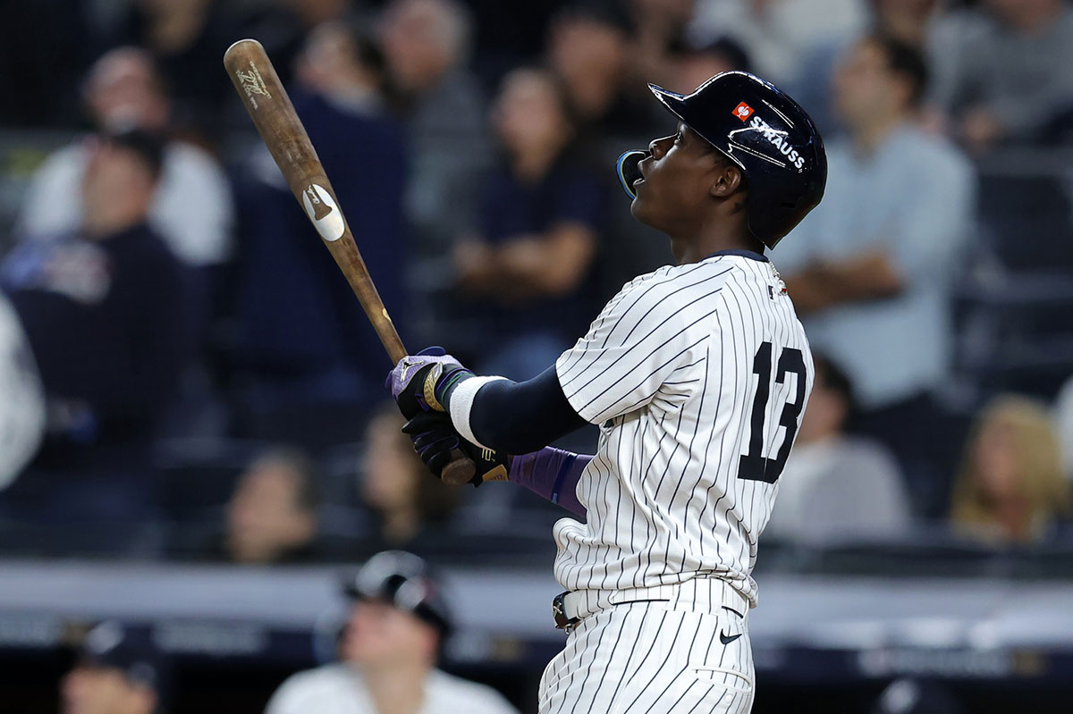 New York Yankees third base Jazz Chisholm Jr. (13) hits a solo home run against the Kansas City Royals in the ninth inning during game two of the ALDS for the 2024 MLB Playoffs at Yankee Stadium.