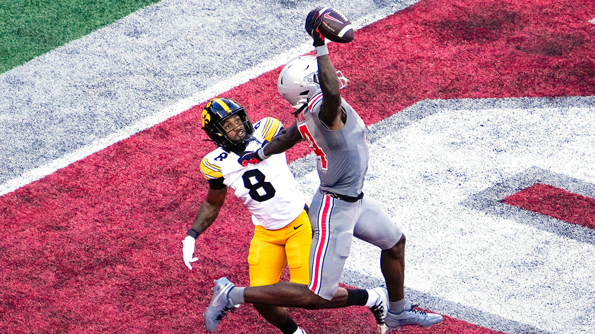 Oct 5, 2024; Columbus, Ohio, USA; Ohio State Buckeyes wide receiver Jeremiah Smith (4) makes a one-handed touchdown catch against Iowa Hawkeyes defensive back Deshaun Lee (8) in the third quarter at Ohio Stadium on Saturday.