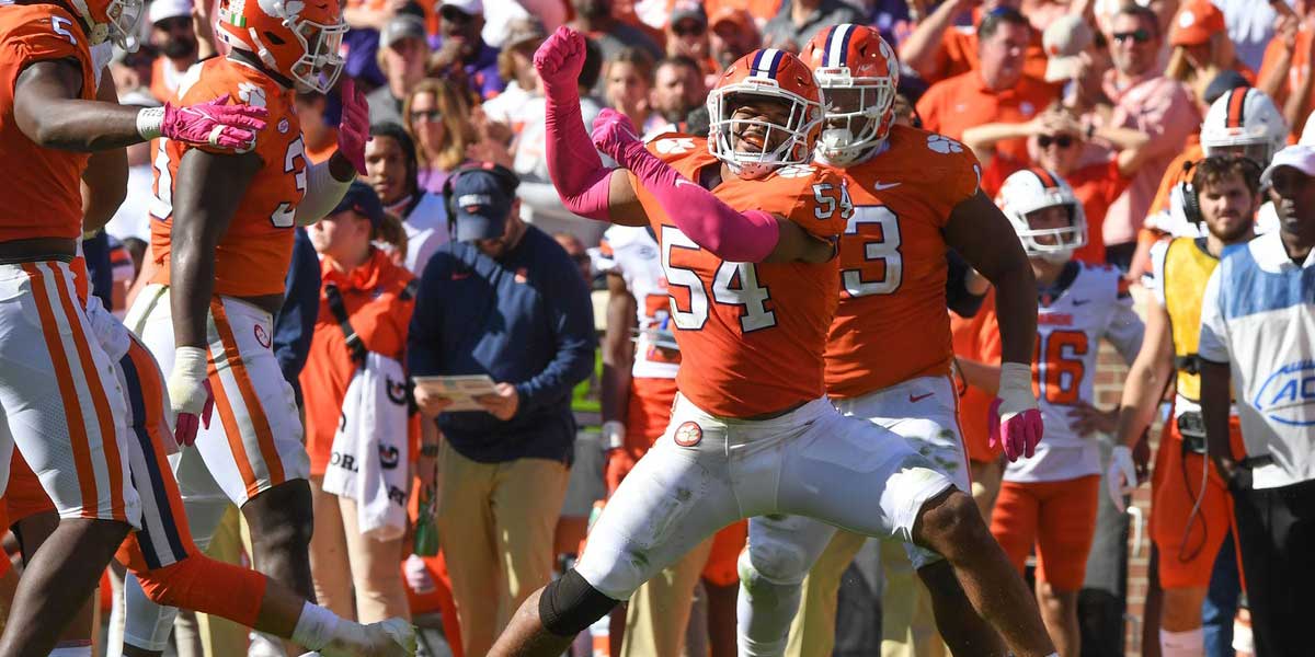 Clemson linebacker Jeremiah Trotter Jr. (54) celebrates tackling Syracuse quarterback Garrett Shrader (6) during the fourth quarter at Memorial Stadium in Clemson, S.C., on Oct. 22, 2022.