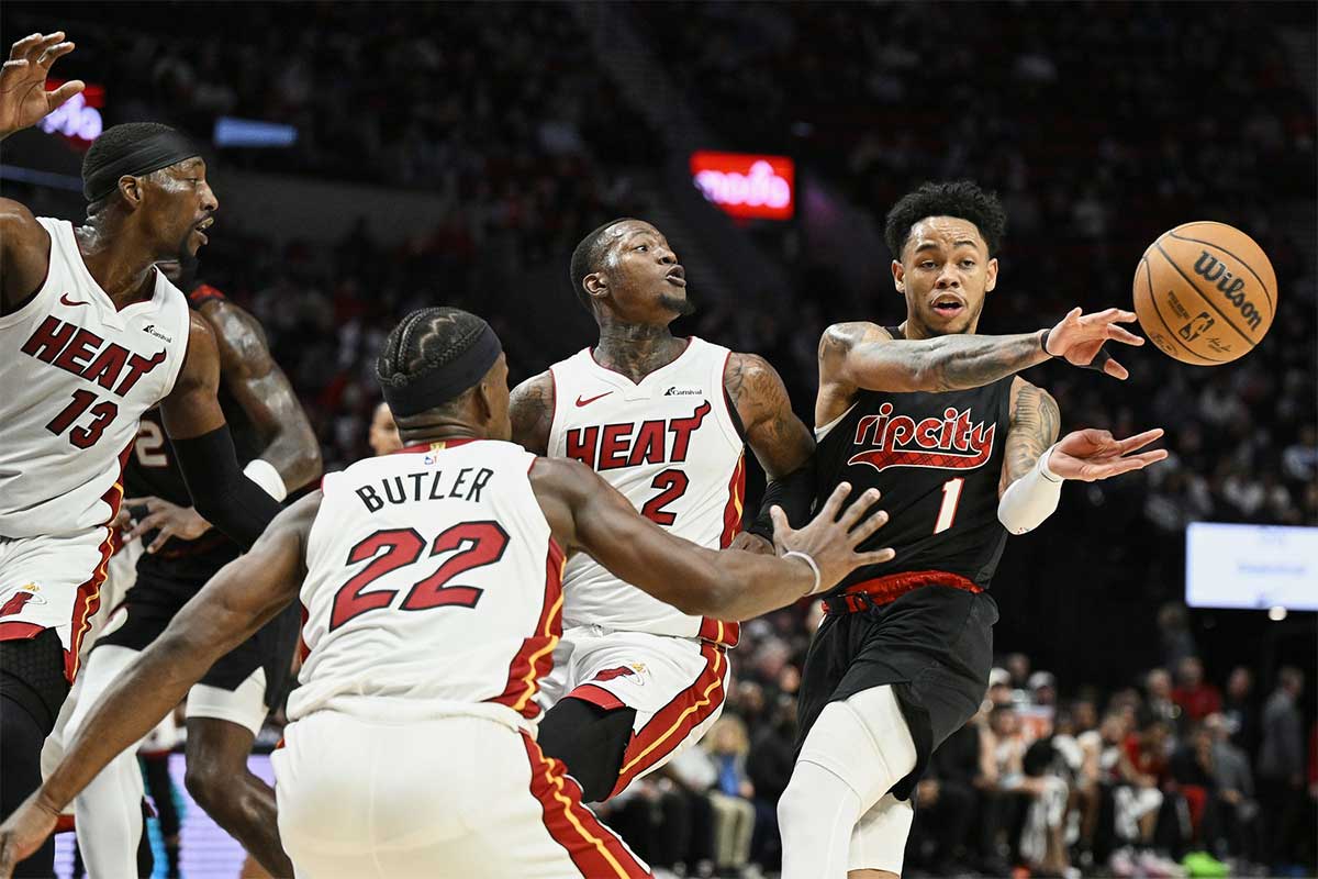 Portland Trail Blazers guard Anfernee Simons (1) passes the ball during the first half against Miami Heat guard Terry Rozier (2), forward Jimmy Butler (22), and center Bam Adebayo (13) at Moda Center.
