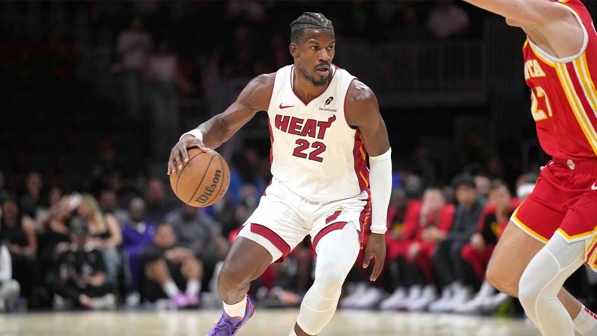 Miami Heat forward Jimmy Butler (22) brings the ball up the court as Atlanta Hawks guard Vit Krejci (27) defends in the first half at Kaseya Center.