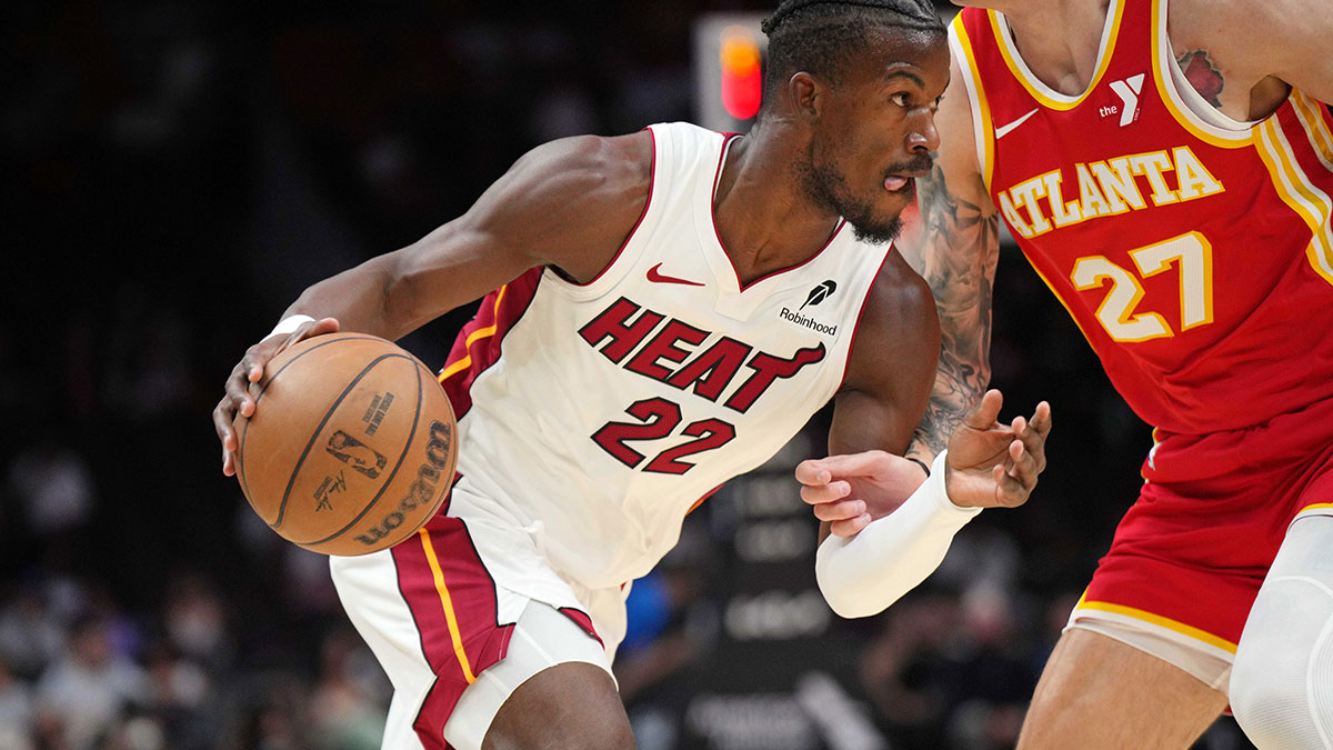 Miami Heat forward Jimmy Butler (22) drives past Atlanta Hawks guard Vit Krejci (27) in the first half at Kaseya Center.