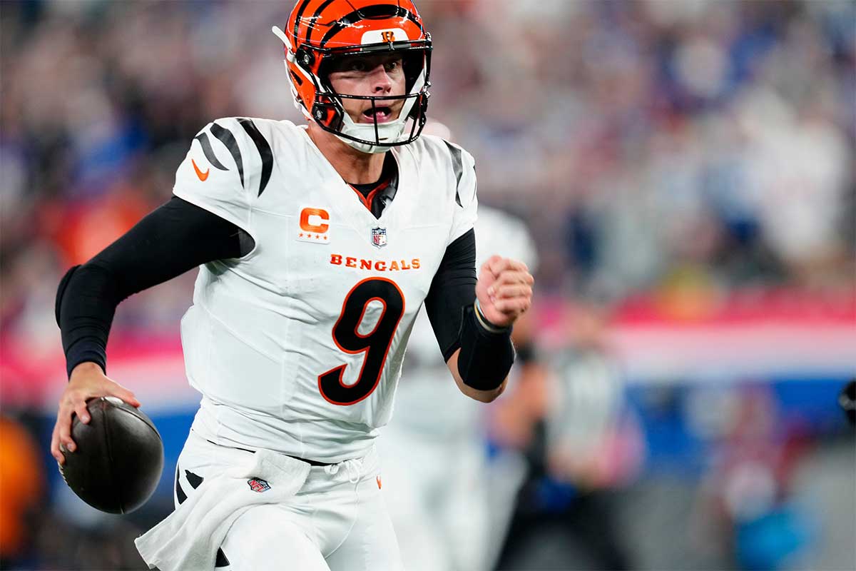 Cincinnati Bengals quarterback Joe Burrow (9) runs for a touchdown to score the first points of the game, Sunday, October 13, 2024, in East Rutherford.