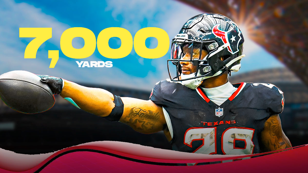 Joe Mixon in a Houston Texans uniform with a sign that says: 7,000 Yards as Mixon has rushed for 7000 yards in his career after the Texans landed him in a trade with the bengals.
