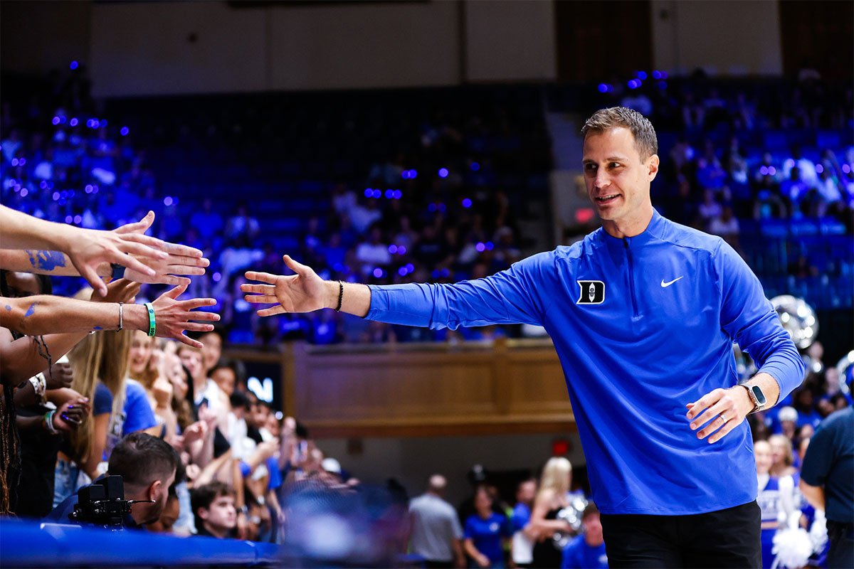 Duke Blue Devils head coach Jon Scheyer reaches for the fans during Countdown to Craziness at Cameron Indoor Stadium.