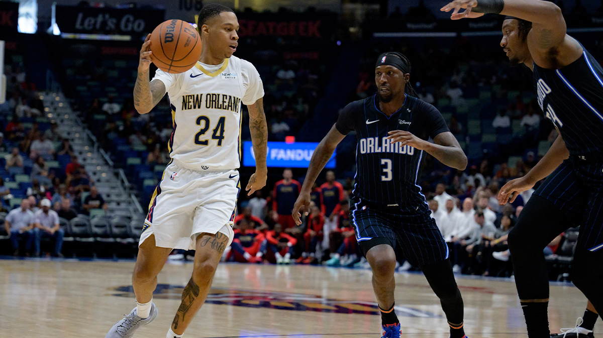 Pelicans guard Jordan Hawkins (24) dribbles next to Orlando Magic center Wendell Carter Jr. (34) and guard Kentavious Caldwell-Pope (3) during the second half at Smoothie King Center. 