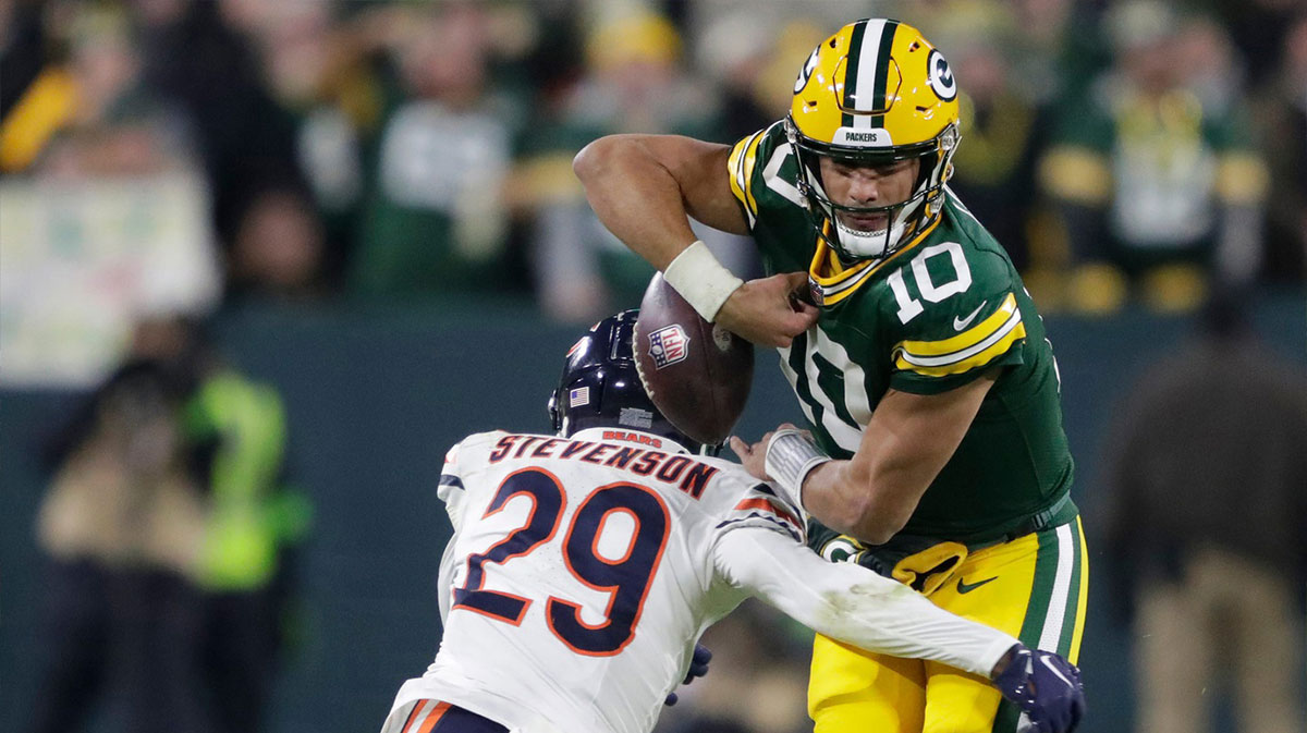 Chicago Bears cornerback Tyrique Stevenson forces a fumble by Green Bay Packers quarterback Jordan Love (10) in the third quarter during their football game Sunday, January 7, 2024, in Green Bay, Wisconsin.