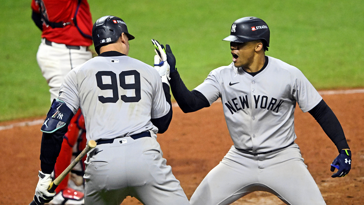 New York Yankees outfielder Juan Soto (22) walks past outfielder Aaron Judge (99) after hitting a three-run home run in the tenth inning against the Cleveland Guardians during Game 5 of the ALCS for the 2024 MLB Playoffs at Progressive Field. Celebrated with.