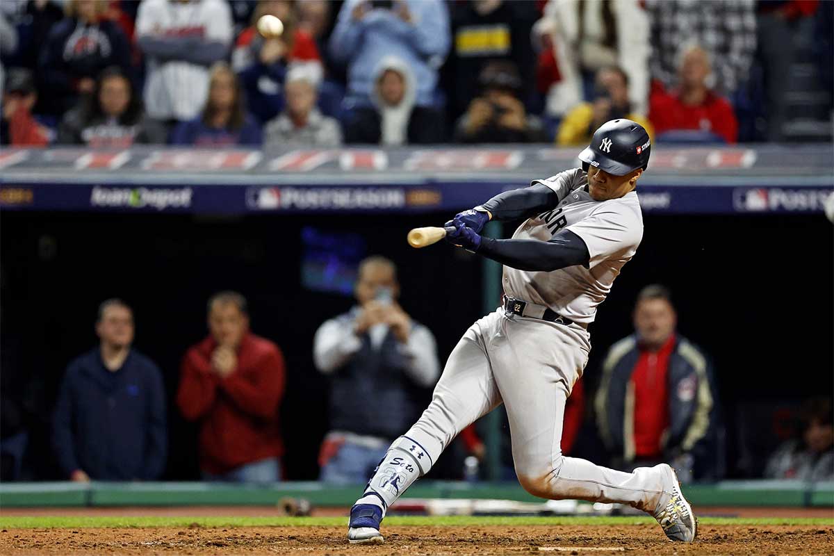 New York Yankees outfielder Juan Soto (22) hits a two run home run during the tenth inning against the Cleveland Guardians during game five of the ALCS for the 2024 MLB playoffs at Progressive Field.