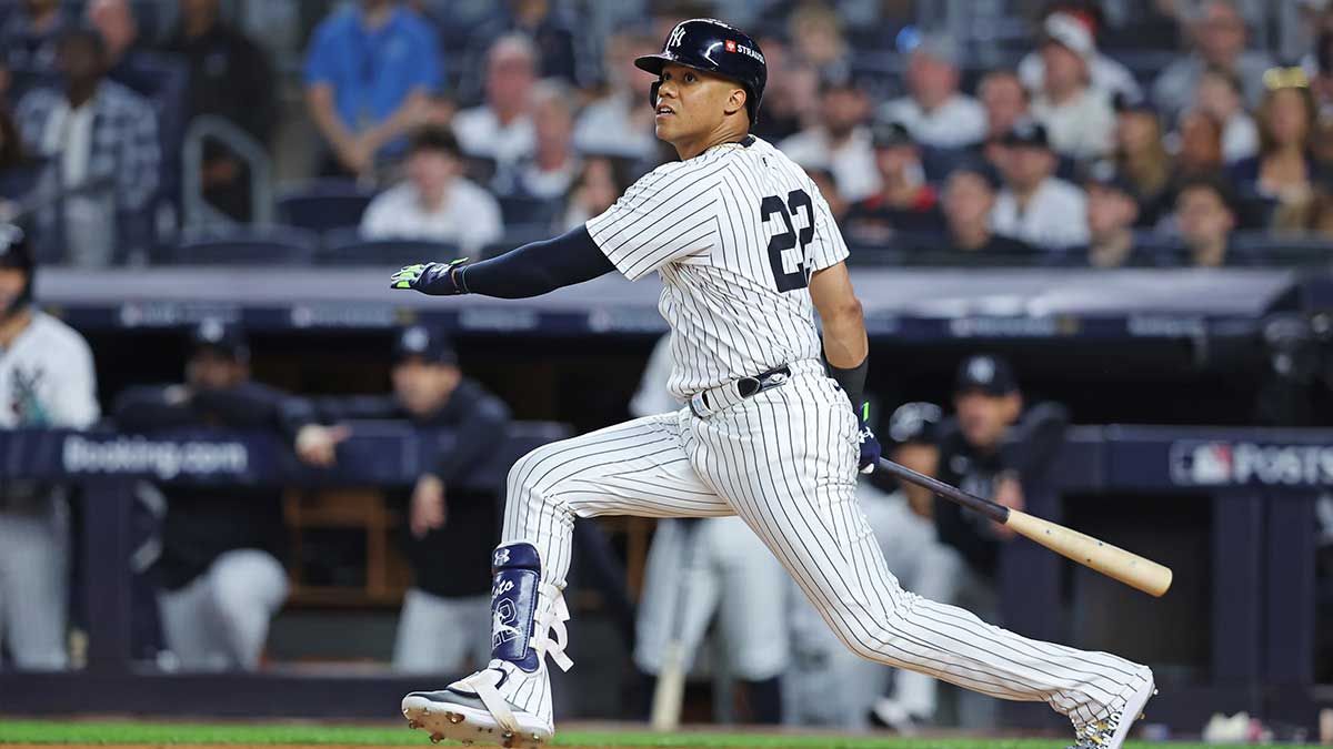 New York Yankees outfielder Juan Soto (22) hits a double during the second inning against the Kansas City Royals during game one of the ALDS for the 2024 MLB Playoffs at Yankee Stadium.