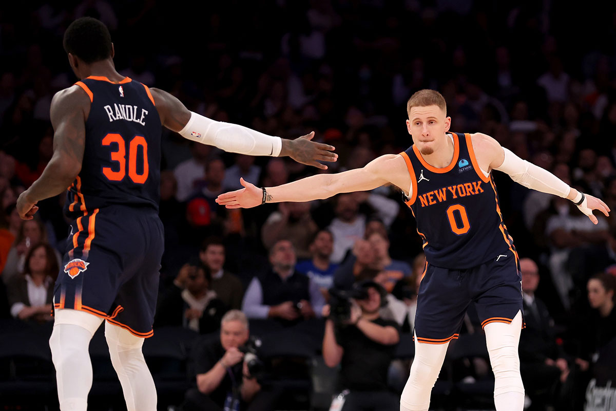 New York Knicks guard Donte DiVincenzo (0) high fives forward Julius Randle (30) during the third quarter against the Denver Nuggets at Madison Square Garden.
