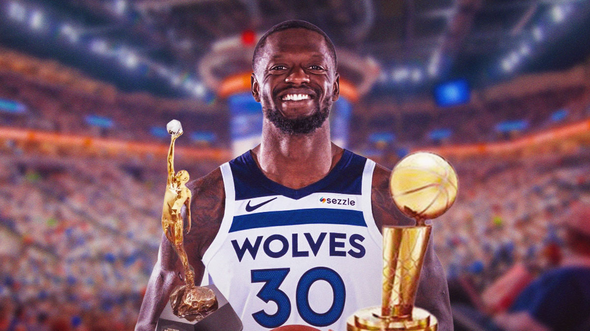 Timberwolves' Julius Randle smiling, with MVP award and Larry O'Brien trophy beside him