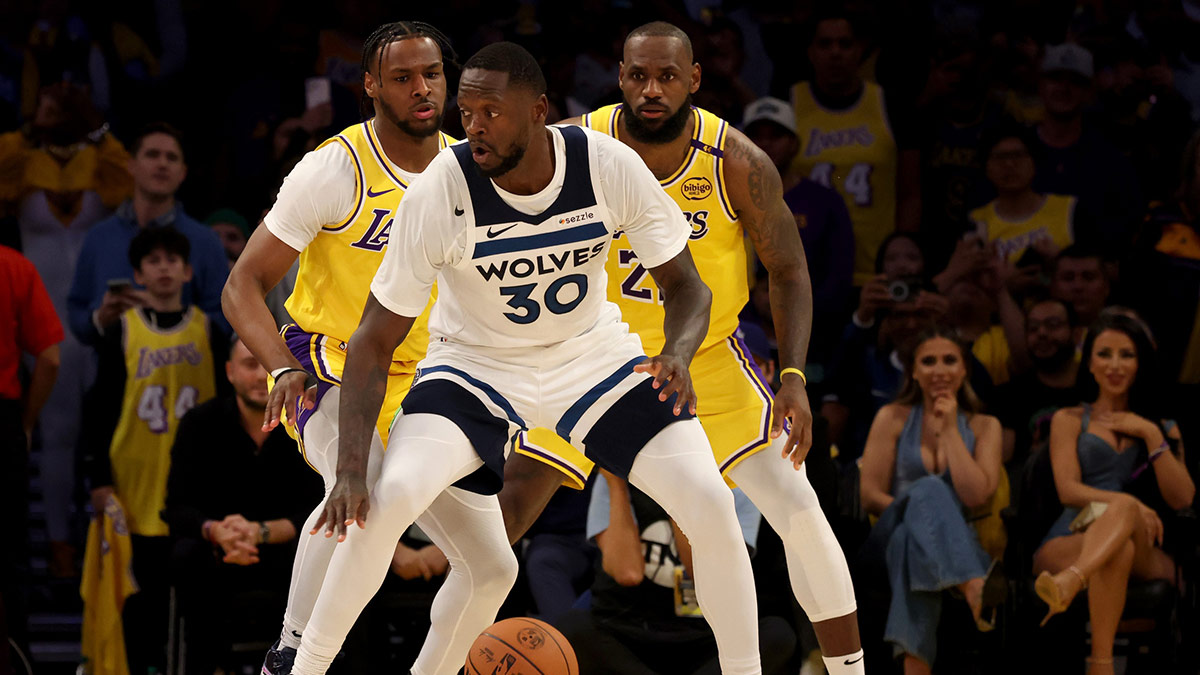Los Angeles Lakers guard Bronny James (9) and forward LeBron James (23) guard Minnesota Timberwolves forward Julius Randle (30) during the second quarter against the Minnesota Timberwolves at Crypto.com Arena. This marked the first time in NBA history that a father and son played together.