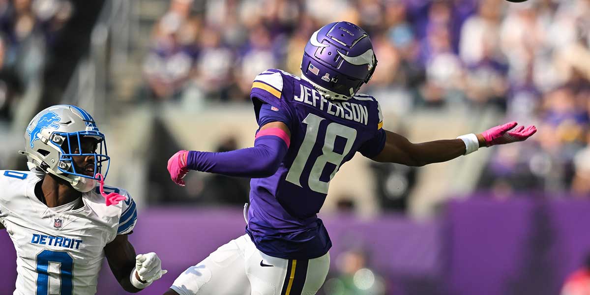 Minnesota Vikings wide receiver Justin Jefferson (18) tries to reach for a pass that falls incomplete as Detroit Lions cornerback Terrion Arnold (0) defends during the second quarter at U.S. Bank Stadium.