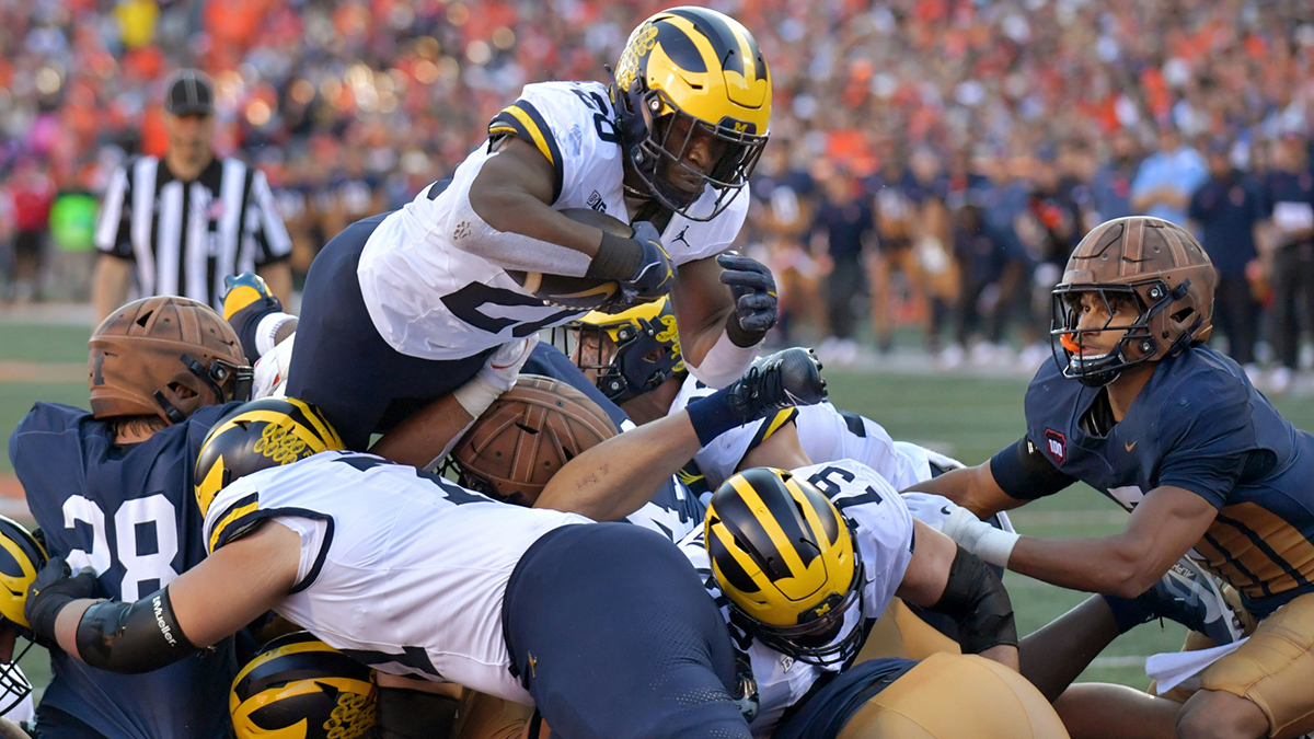 Michigan Wolverines running back Kalel Mullings (20) leaps over the line to score a touchdown against the Illinois Fighting Illini during the first half at Memorial Stadium.