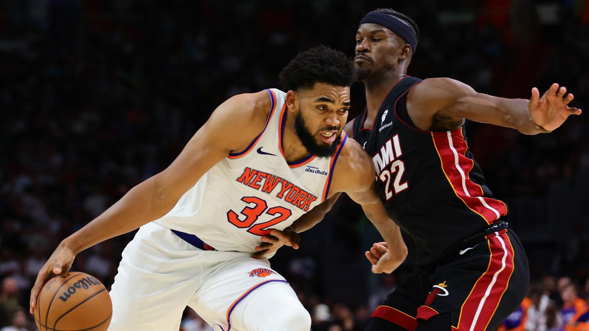 New York Knicks center Karl-Anthony Towns (32) drives to the basketball against Miami Heat forward Jimmy Butler (22) during the fourth quarter at Kaseya Center. 