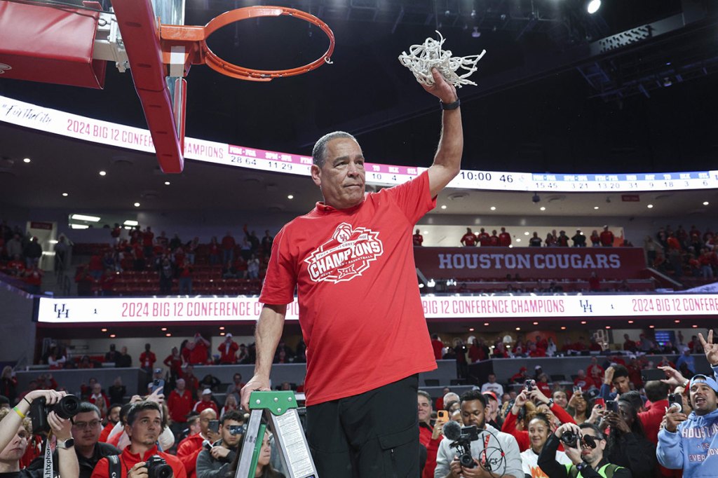 Houston Cougars head coach Kelvin Sampson holds the net after the Houston Cougars defeated the Kansas Jayhawks and win the Big 12 conference championship at Fertitta Center.