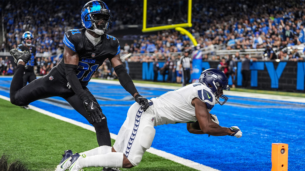 Seattle Seahawks running back Kenneth Walker III (9) scores a touchdown against the Detroit Lions safety Kerby Joseph (31) at Ford Field in Detroit, Tuesday, Oct. 1, 2024.