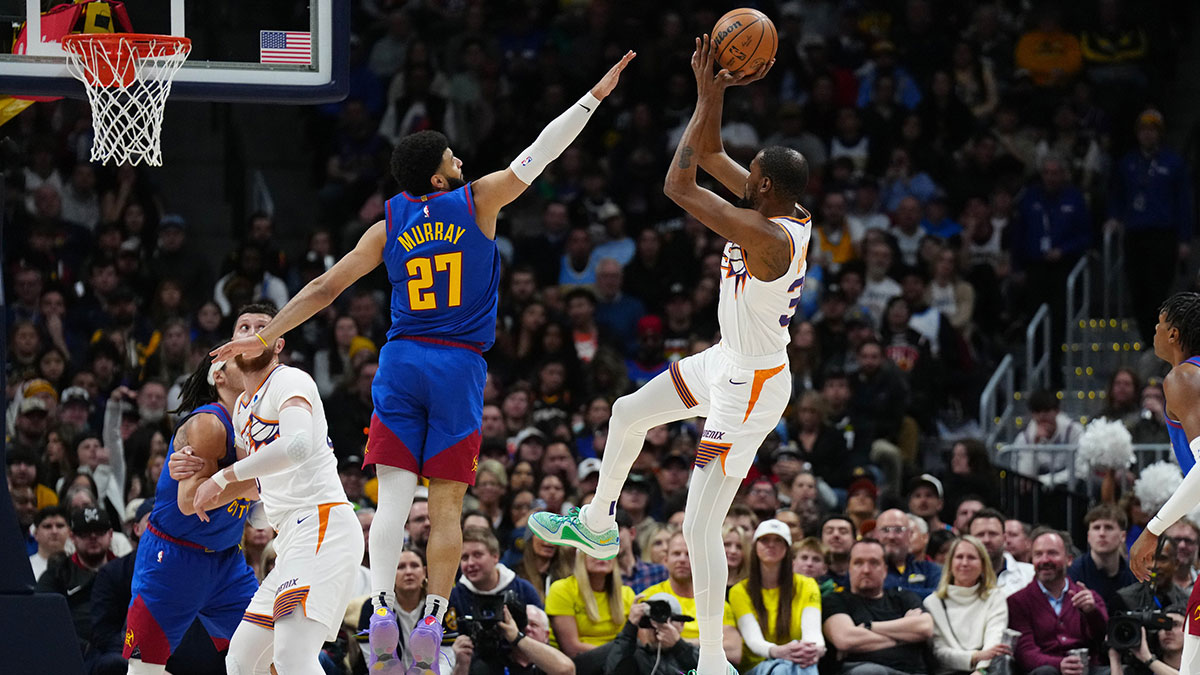 Phoenix Suns forward Kevin Durant (35) shoots the ball over Denver Nuggets guard Jamal Murray (27) in the first half at Ball Arena.