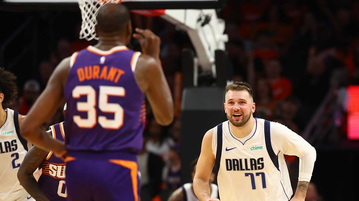 Dallas Mavericks guard Luka Doncic (77) looks on as Phoenix Suns forward Kevin Durant (35) gestures to him in the second half at Footprint Center.