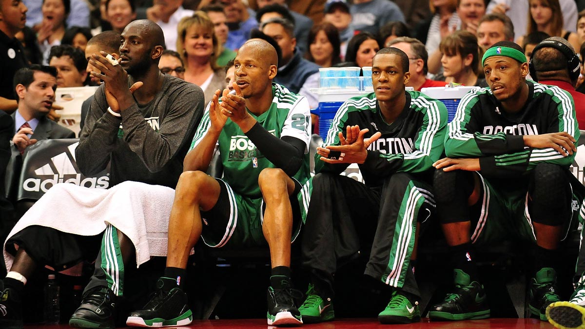 Boston Celtics players from left power forward Kevin Garnett , shooting guard Ray Allen , point guard Rajon Rondo and small forward Paul Pierce watch game action from the bench against the Los Angeles Clippers during the first half at the Staples Center.