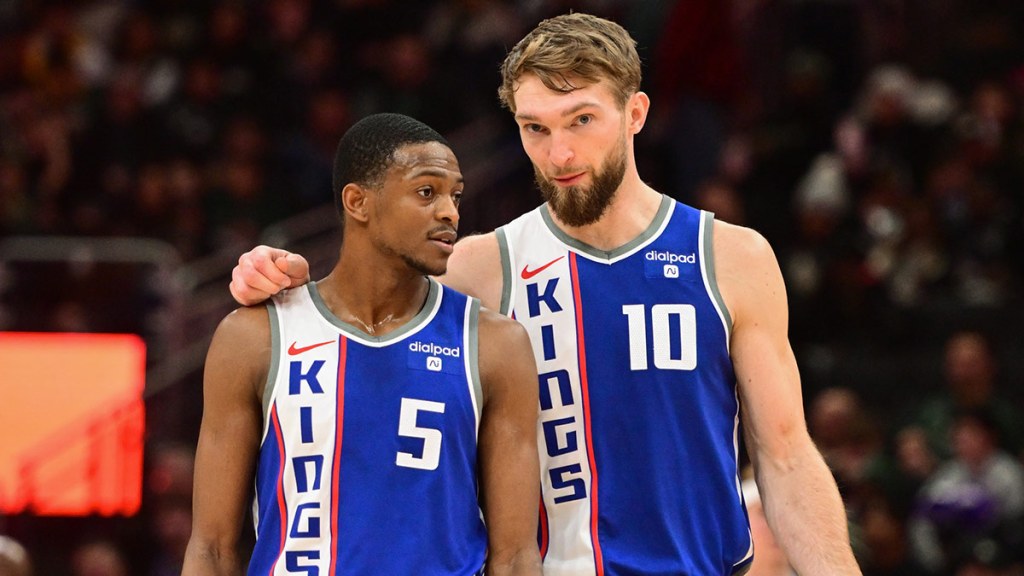 Sacramento Kings guard De'Aaron Fox (5) and center Domantas Sabonis (10) talk during a timeout in the third quarter against the Milwaukee Bucks at Fiserv Forum.