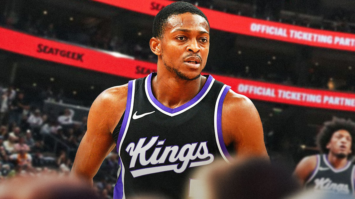 De'Aaron Fox in Kings gear. Kings logo in the background.