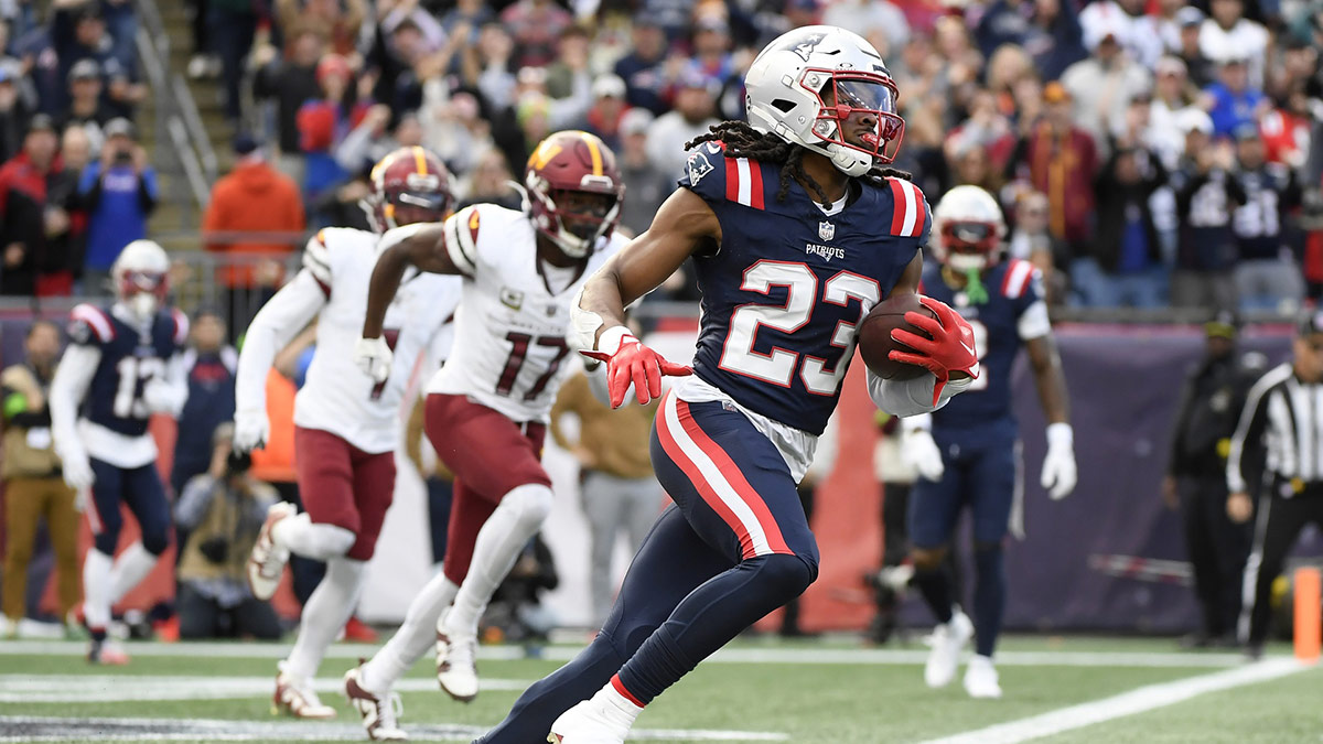 New England Patriots safety Kyle Dugger (23) runs the ball out of the end zone after an interception during the first half against the Washington Commanders at Gillette Stadium.