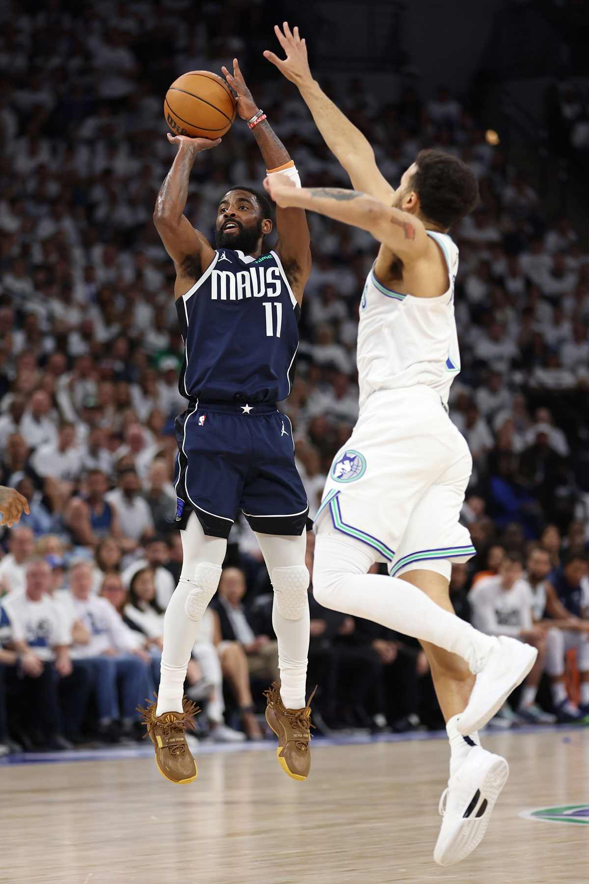Dallas Mavericks guard Kyrie Irving (11) shoots against Minnesota Timberwolves forward Kyle Anderson (1) in the first quarter during game one of the western conference finals for the 2024 NBA playoffs at Target Center.