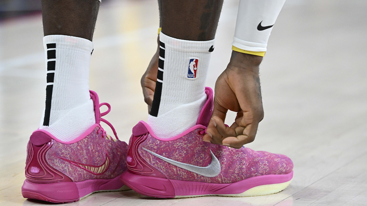 Los Angeles Lakers forward LeBron James (23) ties his Nike shoes against the Golden State Warriors in the second quarter during a preseason game at T-Mobile Arena