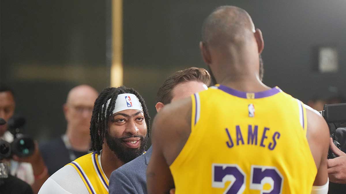 Los Angeles Lakers forward Anthony Davis (3) watches as ESPN reporter Dave McMenamin (center) interviews forward LeBron James (23) during media day at the UCLA Health Training Center.