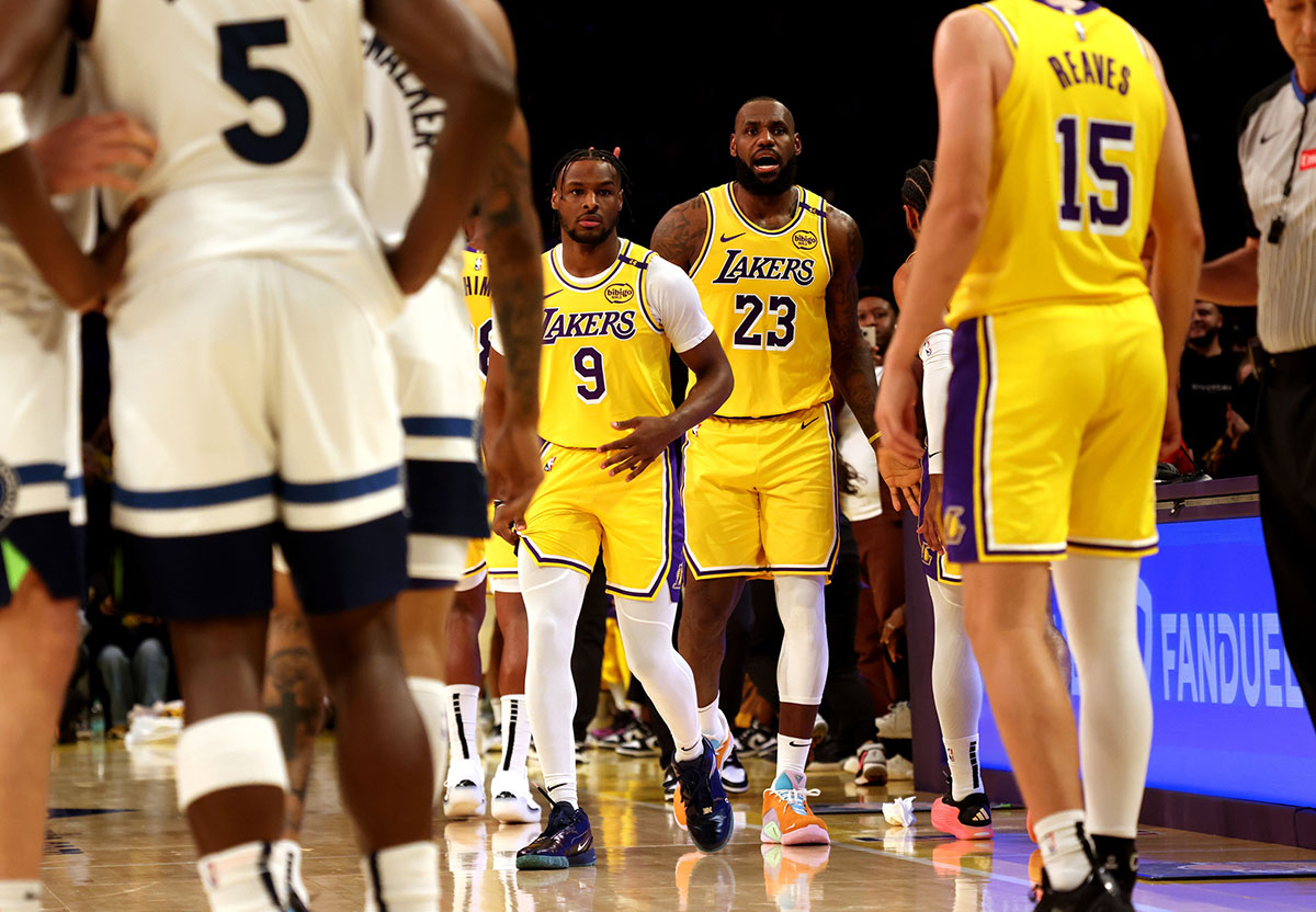 Lakers forward LeBron James (23) checks into the game with his son, guard Bronny James (9) during the second quarter against the Minnesota Timberwolves at Crypto.com Arena. This marked the first time in NBA history that a father and son played together