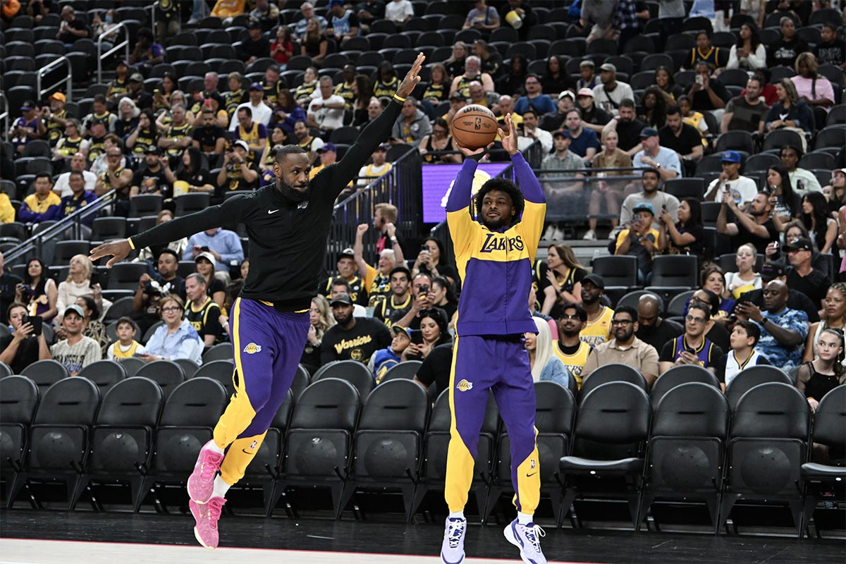 Lakers forward LeBron James (23) warms up with guard Bronny James (9) before the preseason game against the Golden State Warriors at T-Mobile Arena