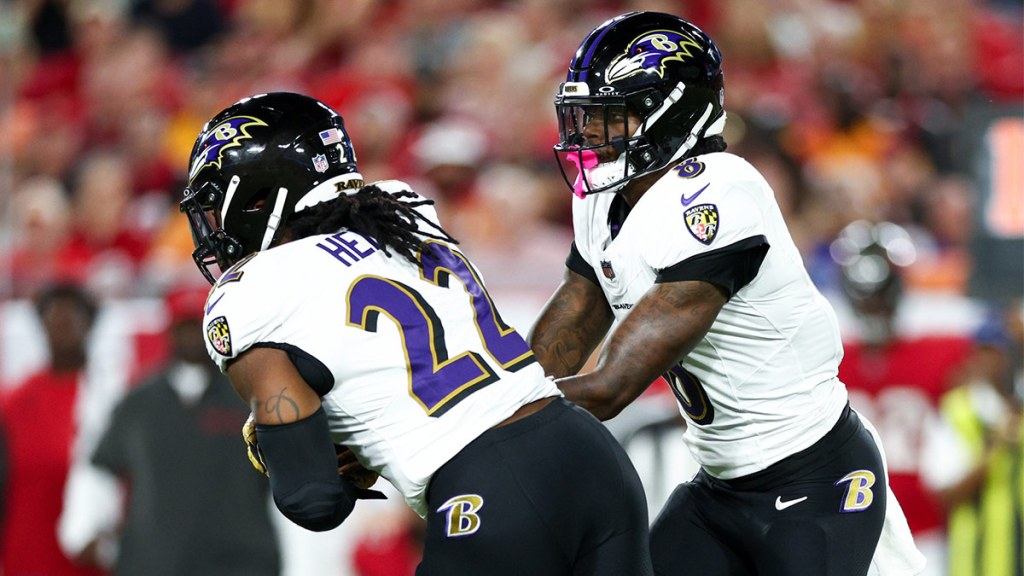 Baltimore Ravens quarterback Lamar Jackson (8) hands off to running back Derrick Henry (22) against the Tampa Bay Buccaneers in the first quarter at Raymond James Stadium.