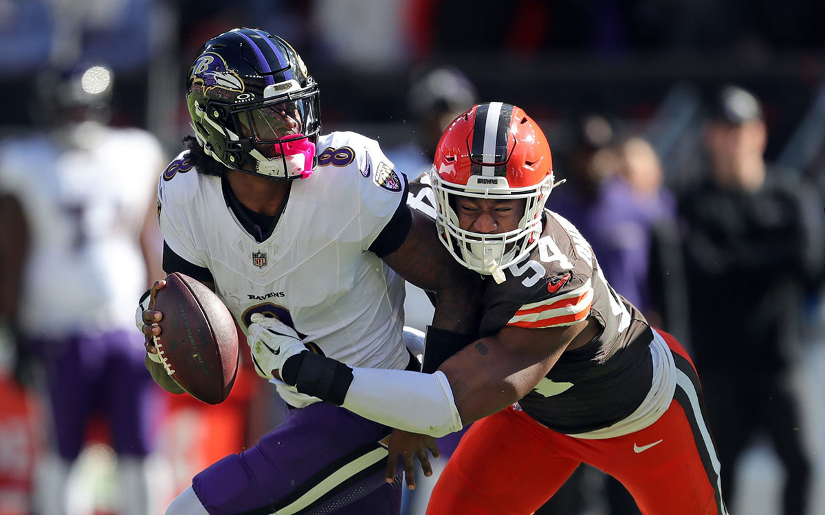 Cleveland Browns defensive end Ogbo Okoronkwo sacks Baltimore Ravens quarterback Lamar Jackson during the first half at Huntington Bank Field.