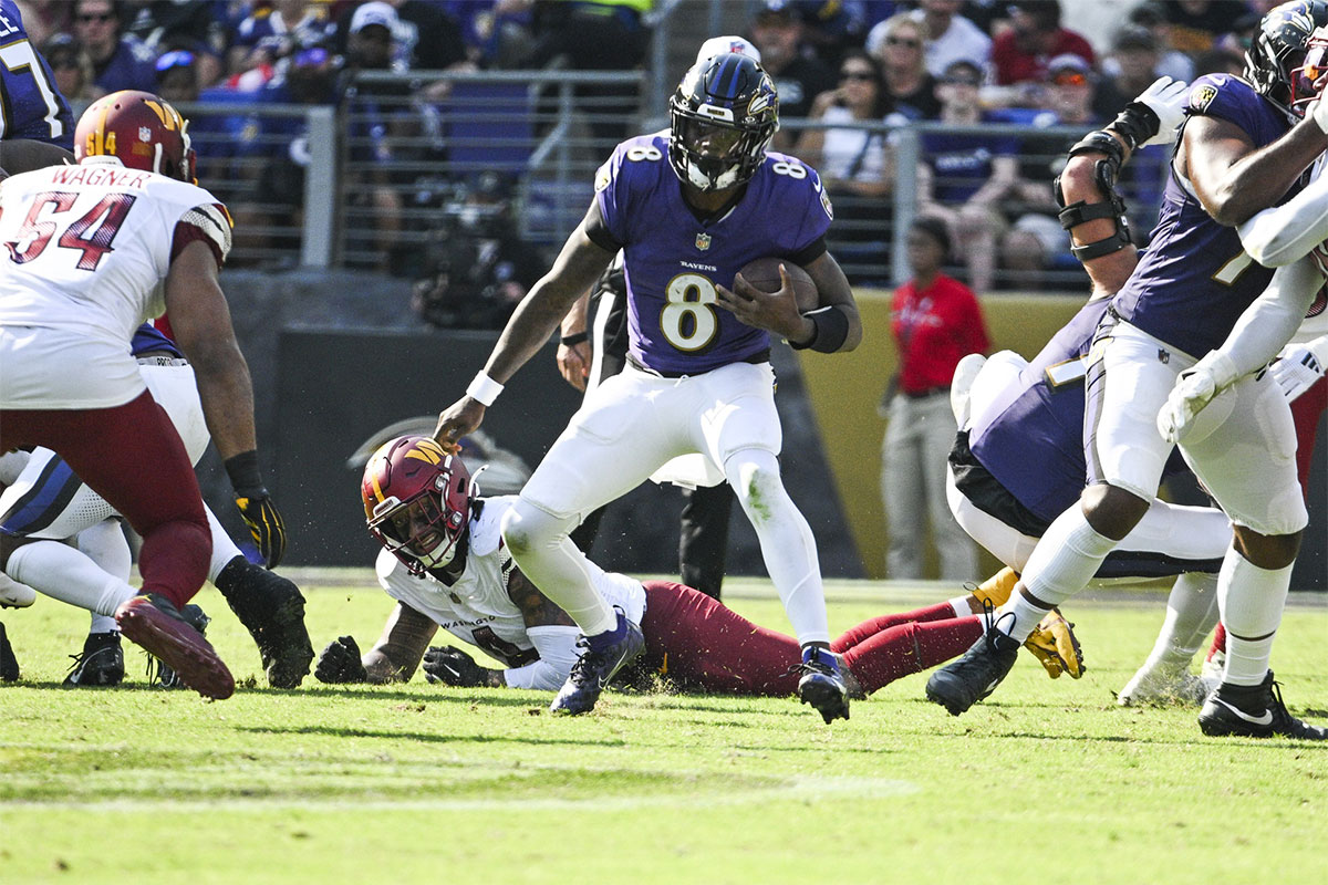 Baltimore Ravens quarterback Lamar Jackson (8) rushes during the second half against the Washington Commanders at M&T Bank Stadium. 