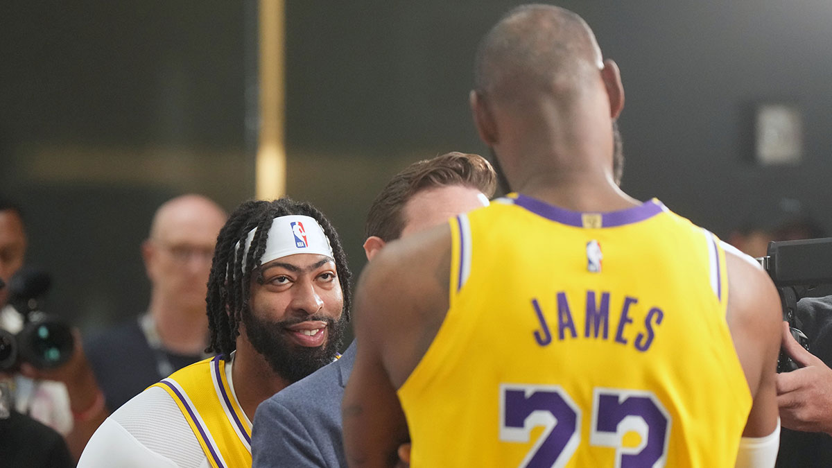 Los Angeles Lakers forward Anthony Davis (3) watches as ESPN reporter Dave McMenamin (center) interviews forward LeBron James (23) during media day at the UCLA Health Training Center.