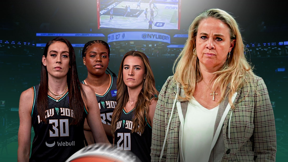 Becky Hammon looking concerned. Liberty players looming over her (Breanna Stewart, Sabrina Ionescu, Jonquel Jones). Barclays Center background