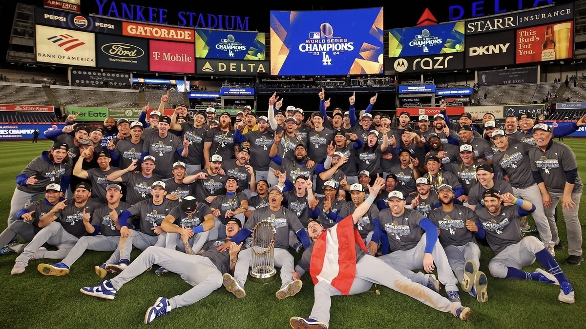 The Los Angeles Dodgers pose for a picture with the Commissioner’s Trophy after beating the New York Yankees in game four to win the 2024 MLB World Series at Yankee Stadium.