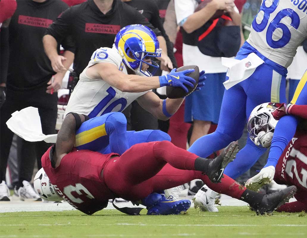 Arizona Cardinals safety Budda Baker (3) tackles Los Angeles Rams wide receiver Cooper Kupp (10) on fourth down during the first quarter at State Farm Stadium.