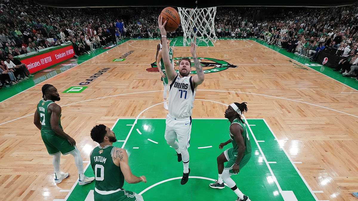 Dallas Mavericks guard Luka Doncic (77) shoots the ball against the Boston Celtics during the fourth quarter in game five of the 2024 NBA Finals at TD Garden.